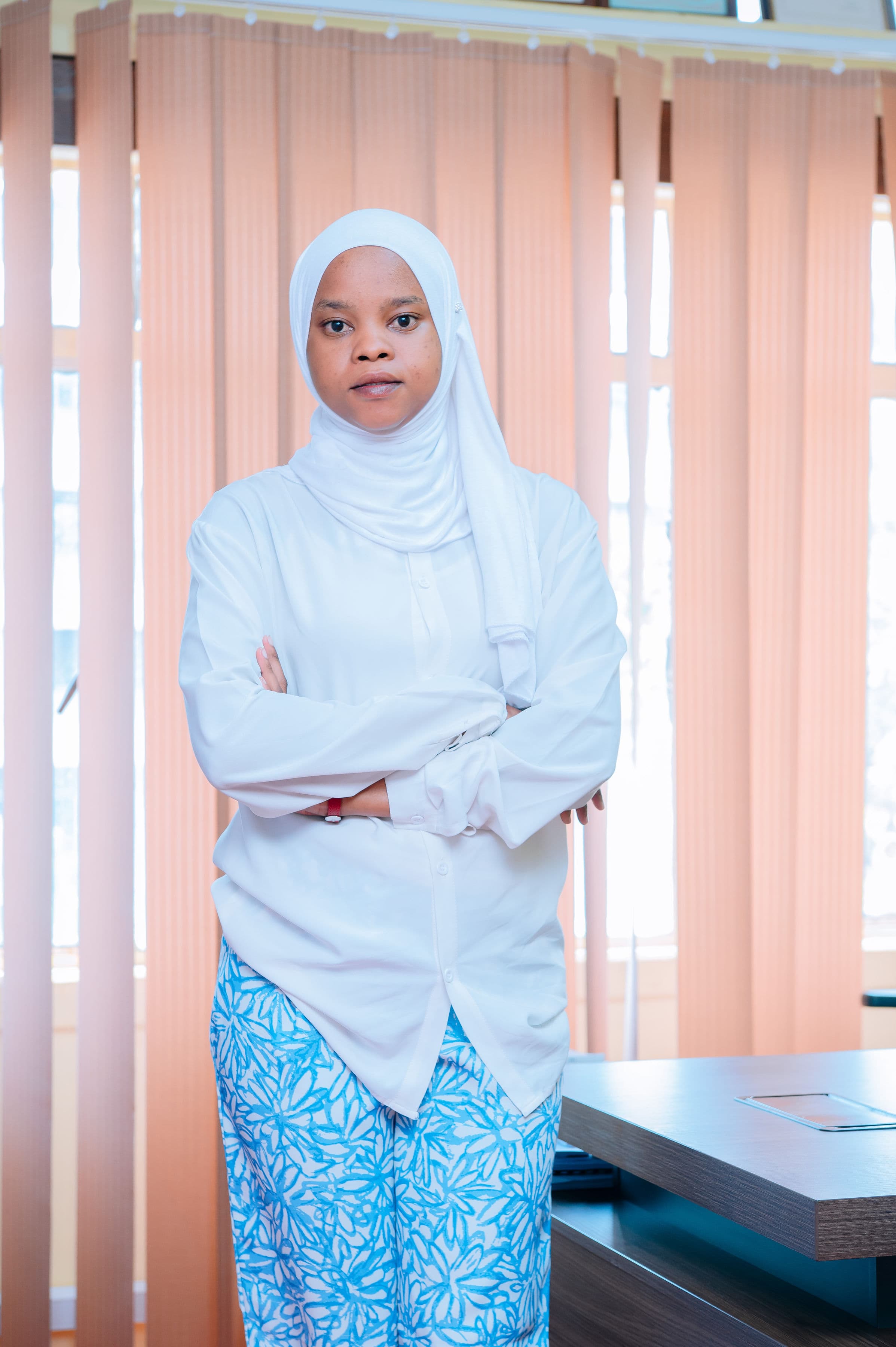 Riami Attorneys team member portrait in white attire